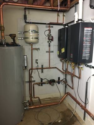 technician installing a modern tankless water heater
